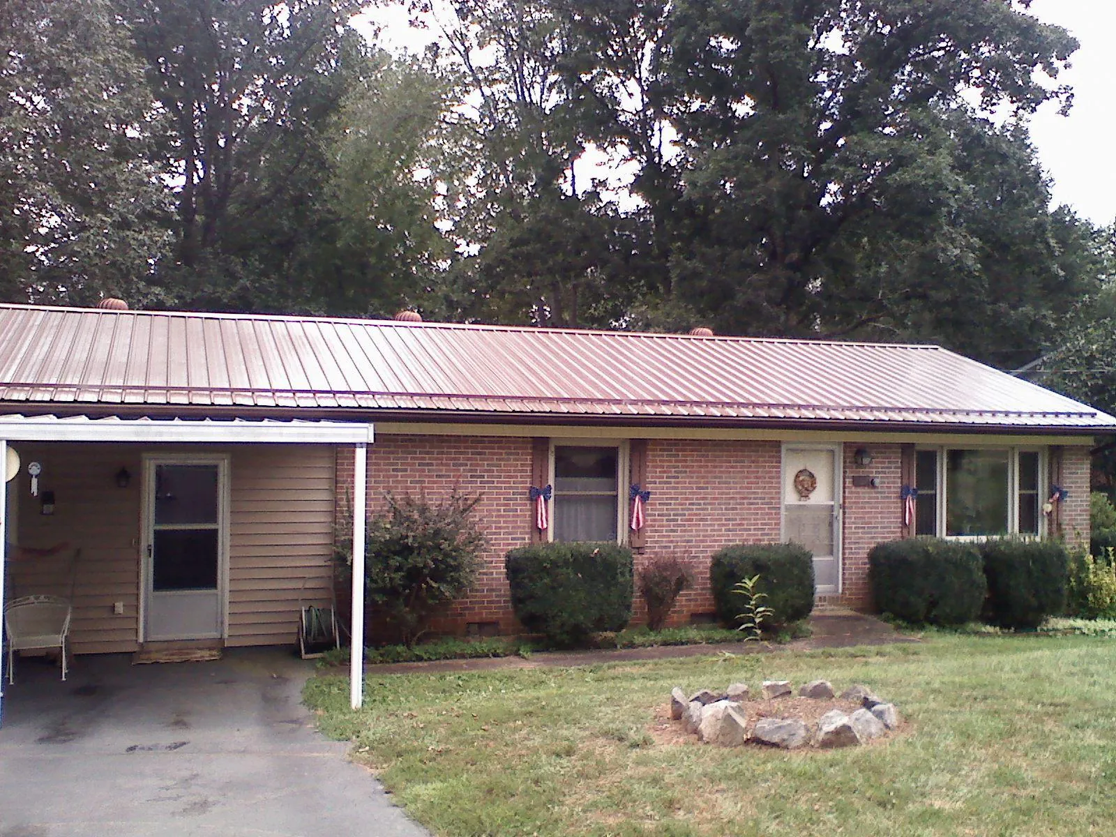 Bronze metal roof and carport on a brick ranch home — Roof Repair work by our crew in Cedar Run